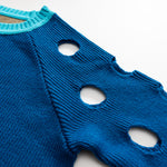 blue sweater with holes in the shoulder